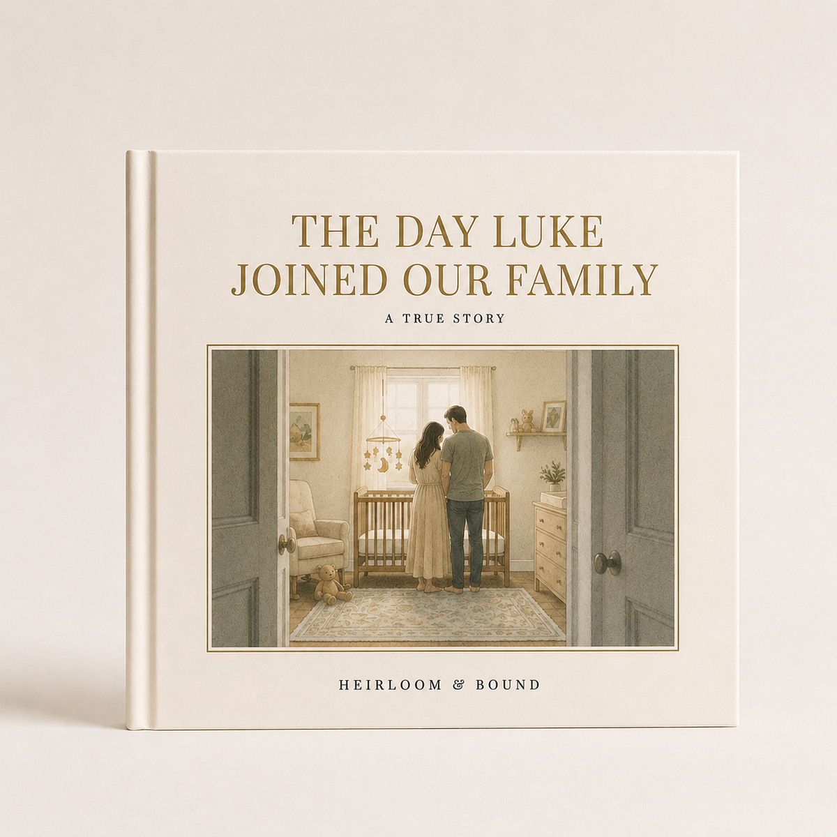 The Day Luke Joined Our Family — Heirloom & Bound custom storybook with a cream hardcover and an illustrated nursery scene of two parents by a crib, shown closed on a table